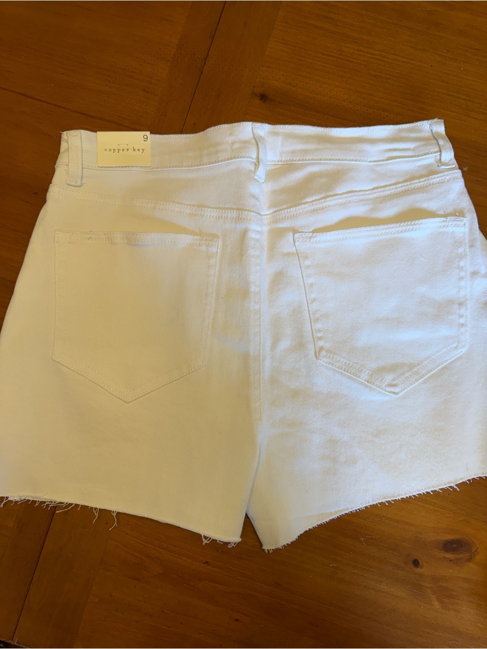 Copper Key White Denim Cutoff Shorts with Frayed Hem